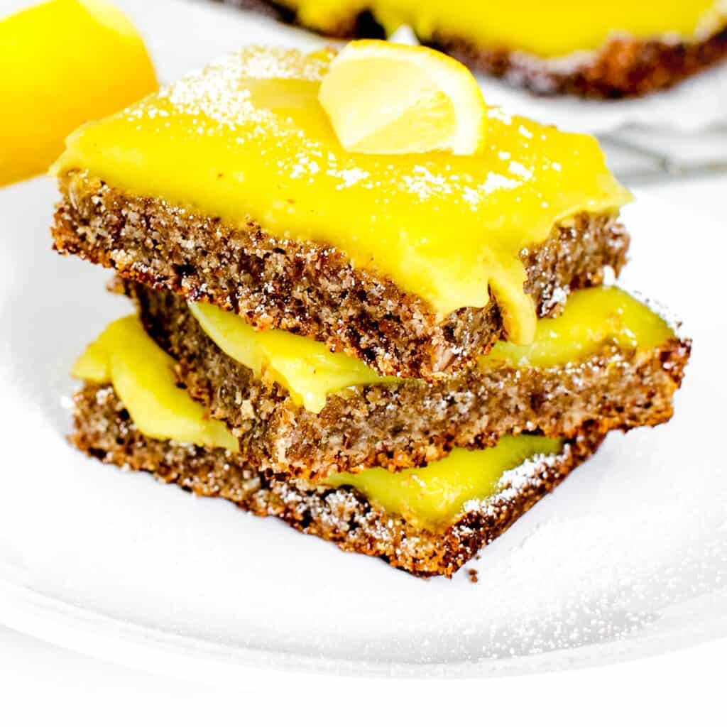 a front view of stacked vegan lemon bars.