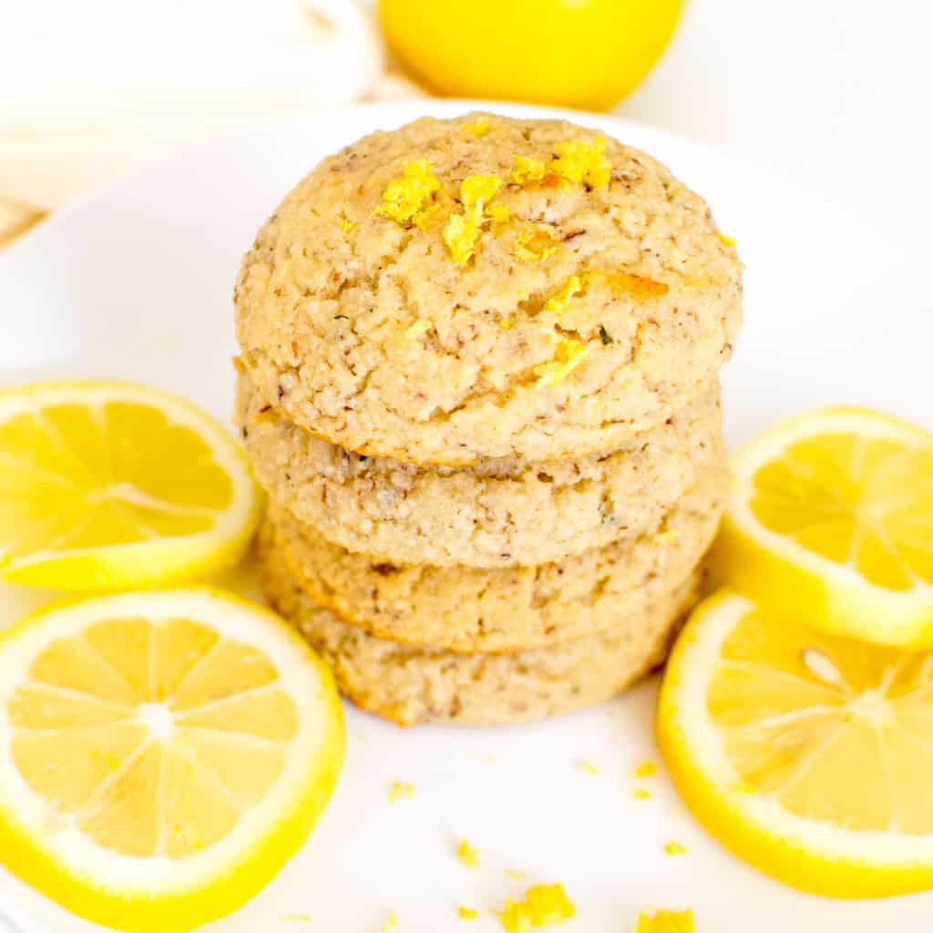 a 45 degree angle view of stacked vegan lemon cookies.