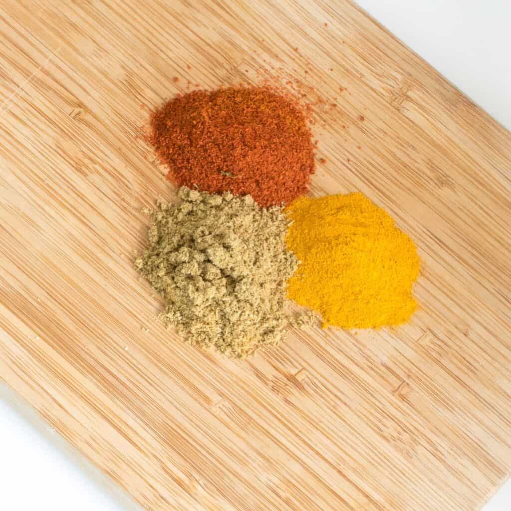 top view of the spices on a wooden board.