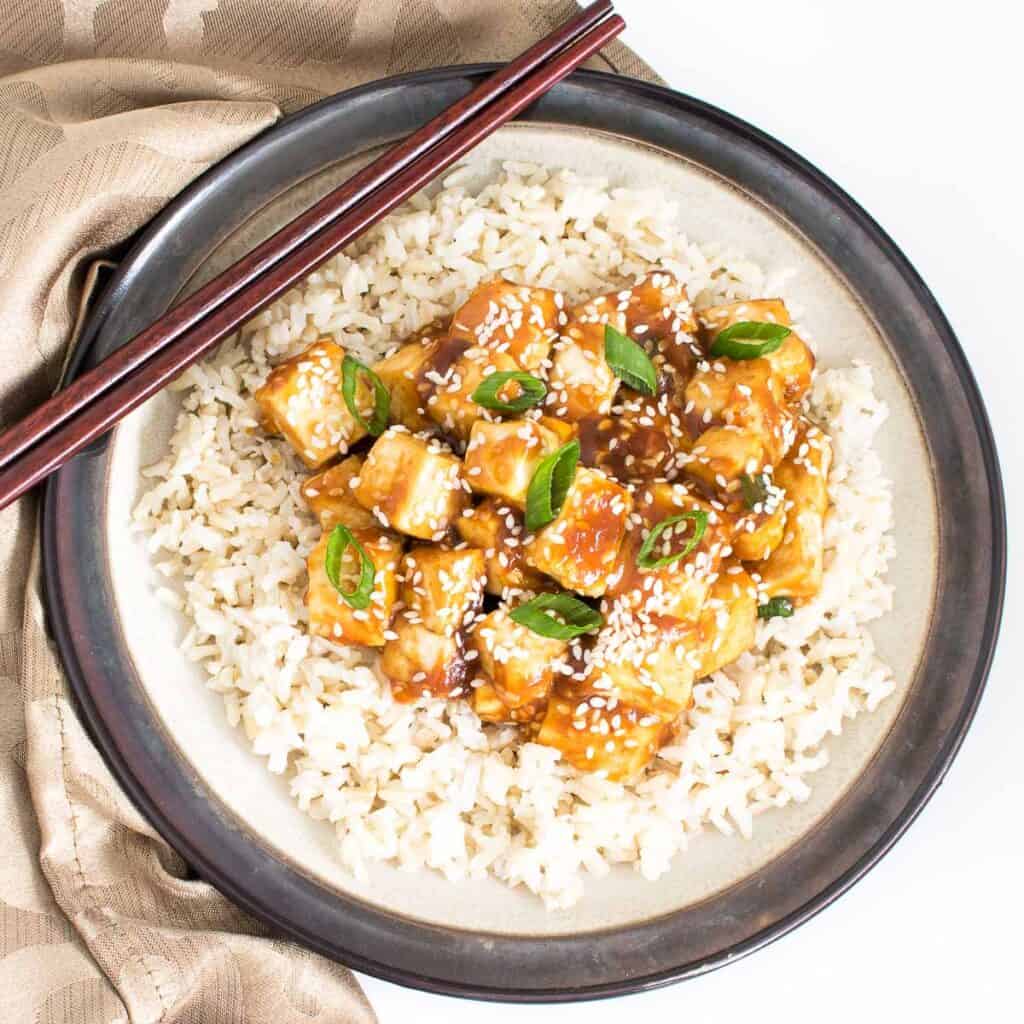 top view of sesame tofu over the bed of brown rice.