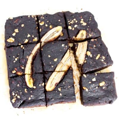 top view of sliced banana brownies with scattered pieces.