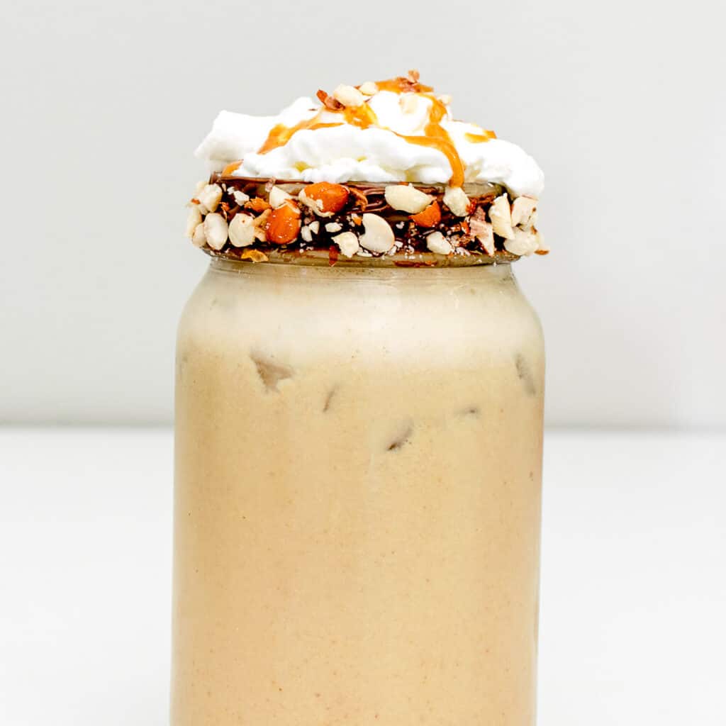 a close up front view of peanut butter milkshake.