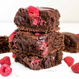 tall stack of raspberry brownies with more of them at the backdrop.