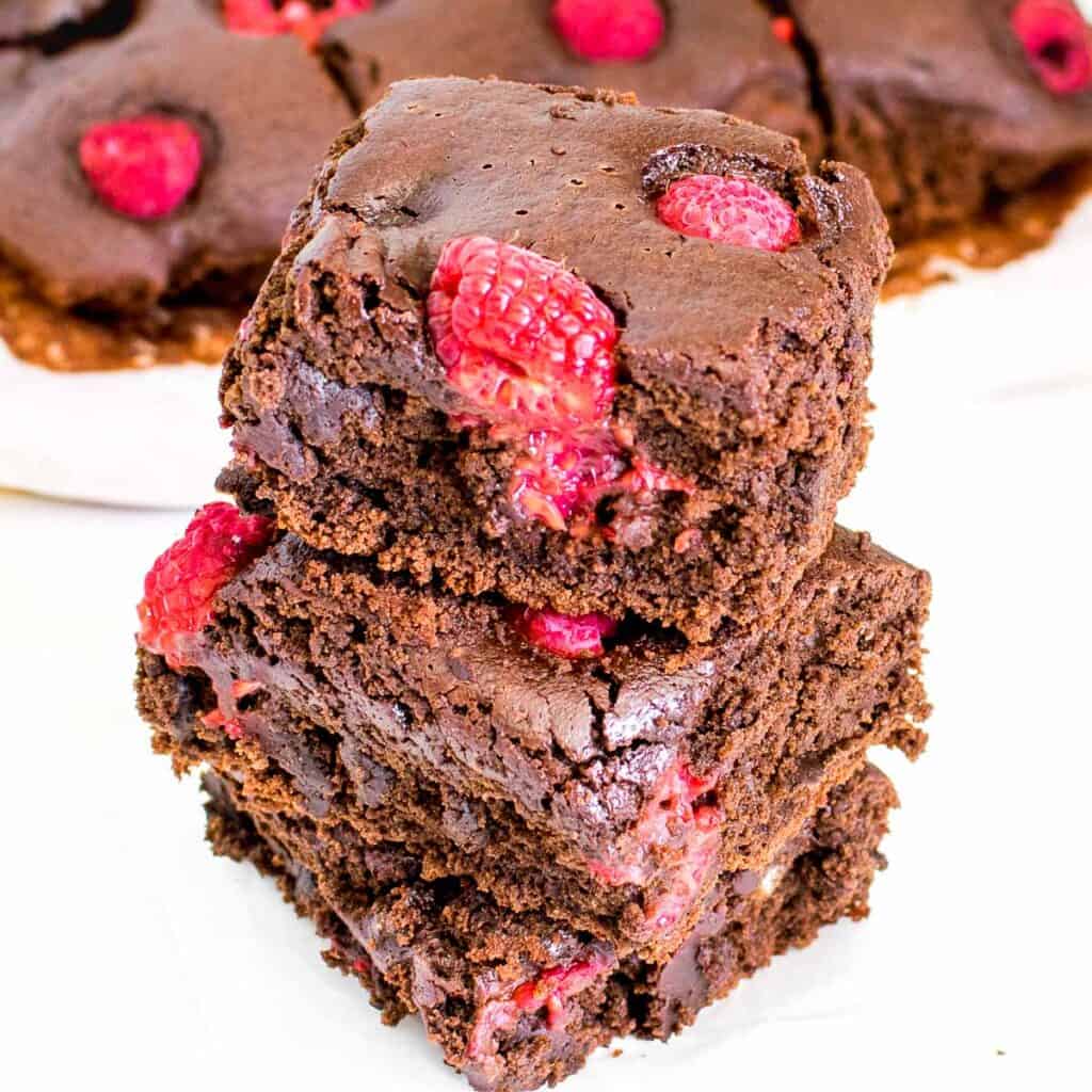 a 45 degree angle of stacked brownies with more of them at the backdrop.