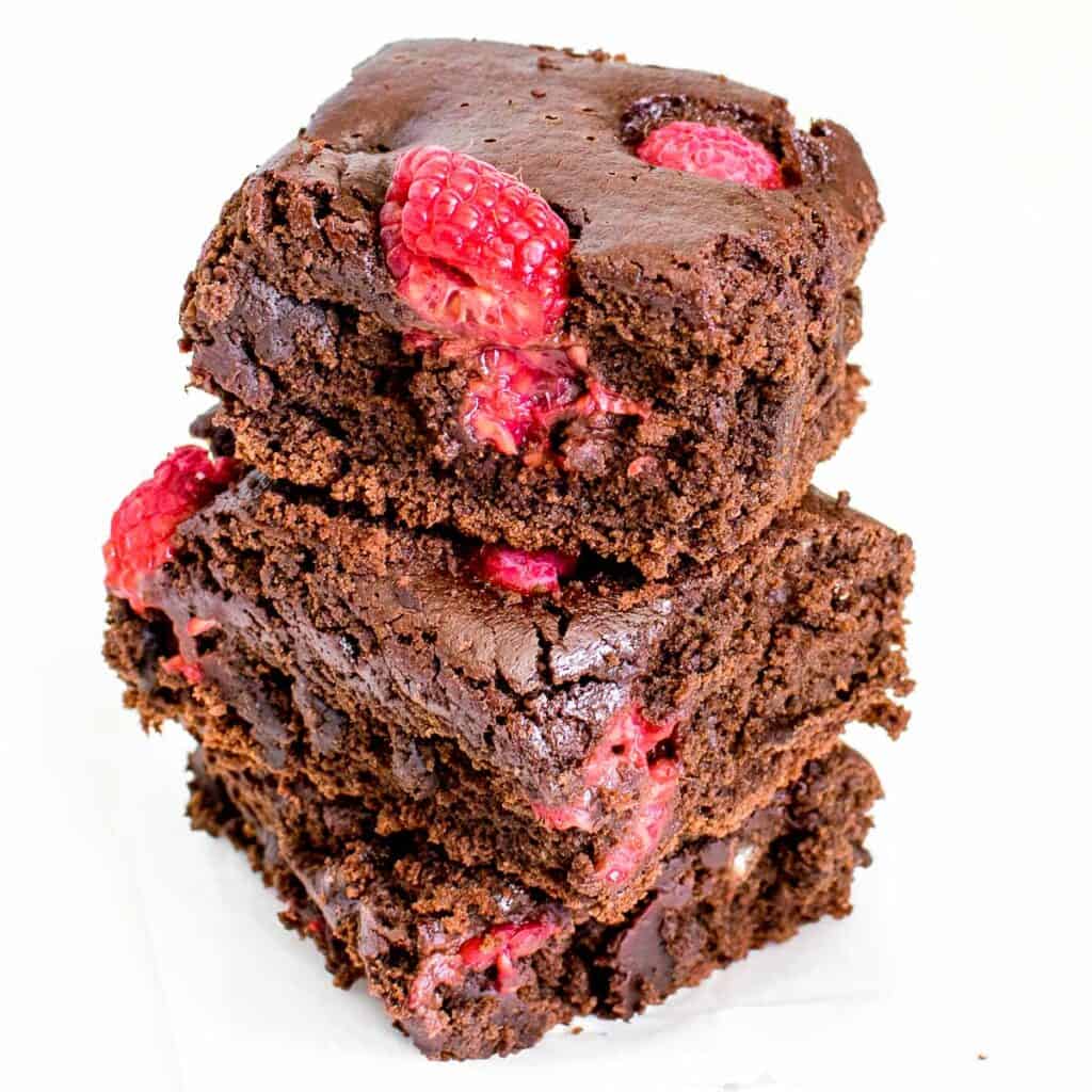 a 45 degree angle view of stacked raspberry brownies.