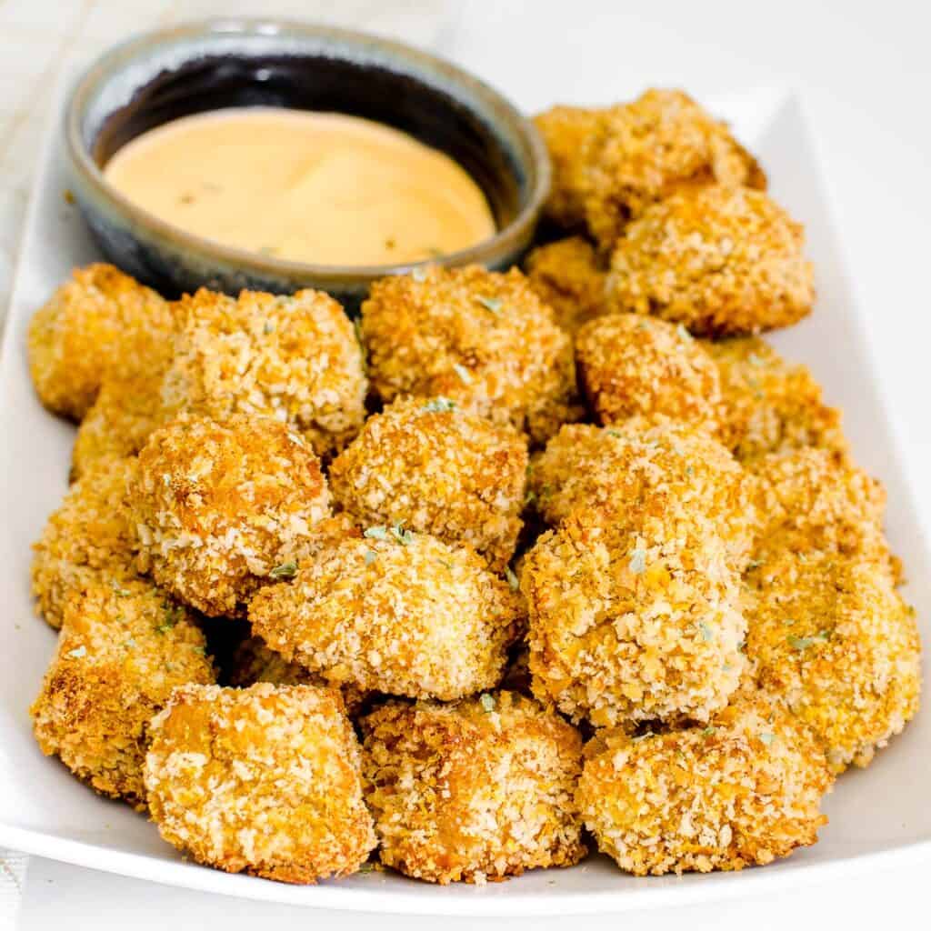 a front view of a plate filled with tofu nuggets.