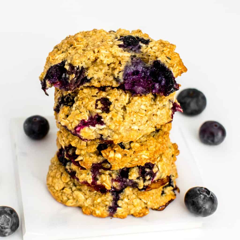 half eaten blueberry oatmeal cookies at the top of its stack. 