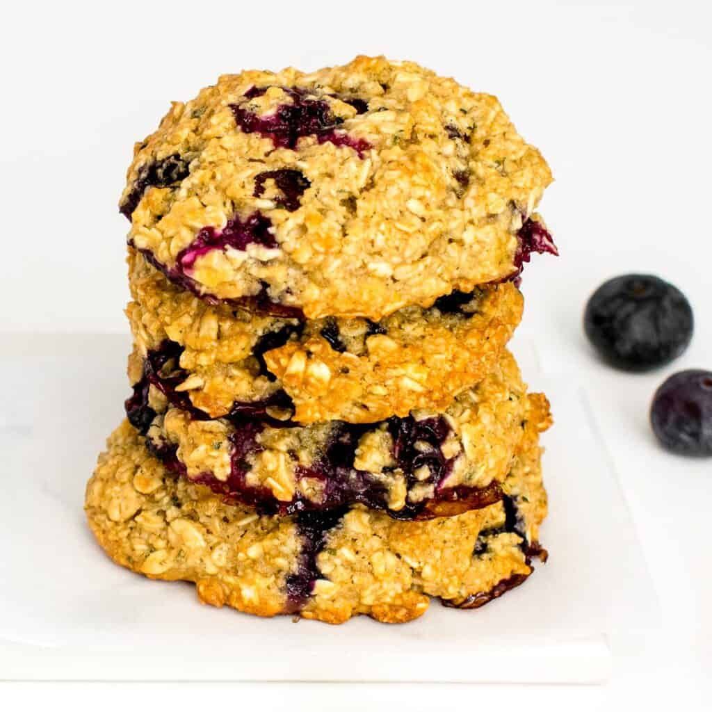 a 45 degree angle view of stacked blueberry oatmeal cookies.
