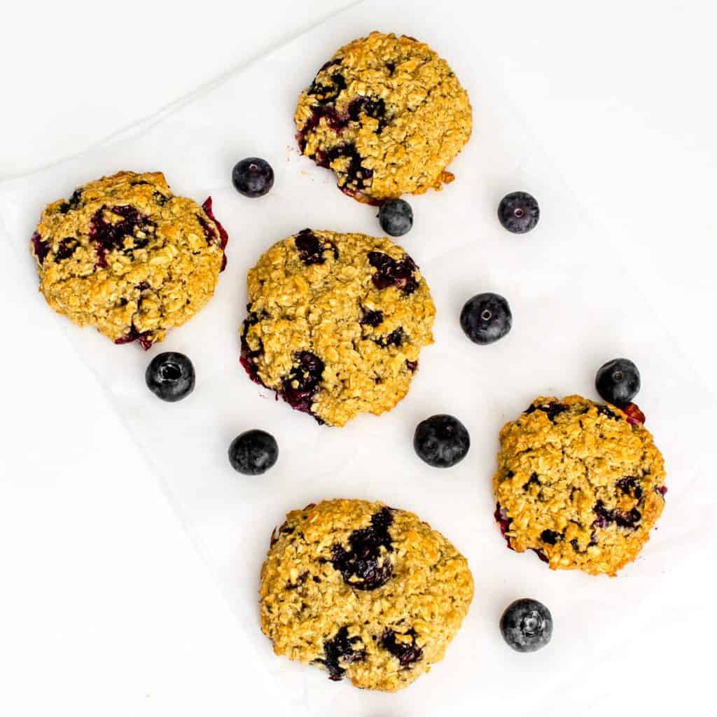 top view of scattered blueberry oatmeal cookies cooling down. 