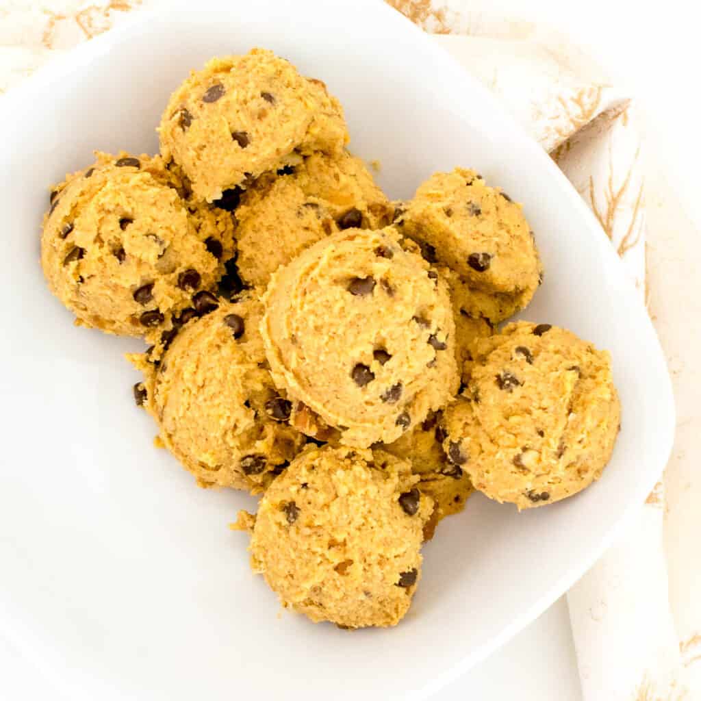 top view of scooped chickpea cookie dough in a bowl.