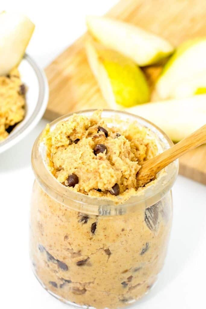 a front view of tall jar filled with chickpea cookie dough. 