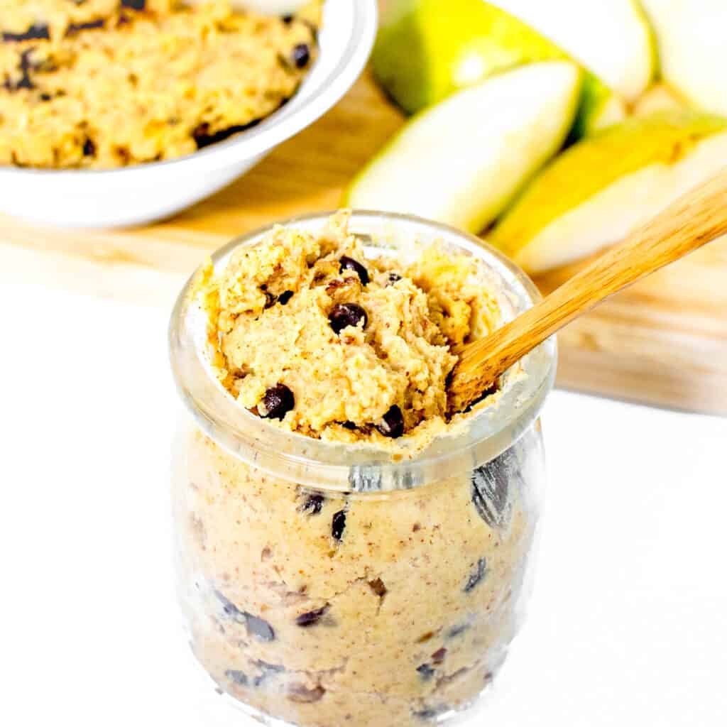 a 45 degree angle view of chickpea cookie dough in a jar. 