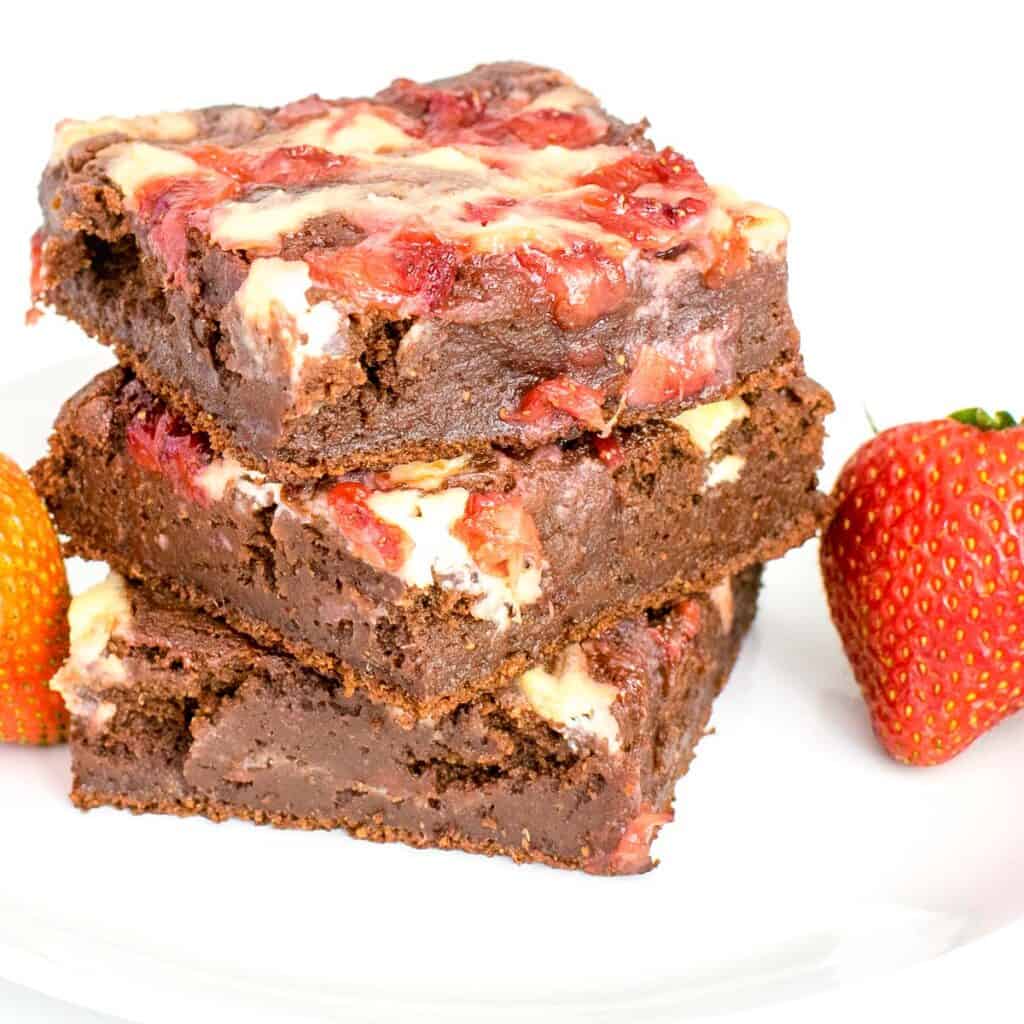 front view of stacked strawberry cheesecake brownies.