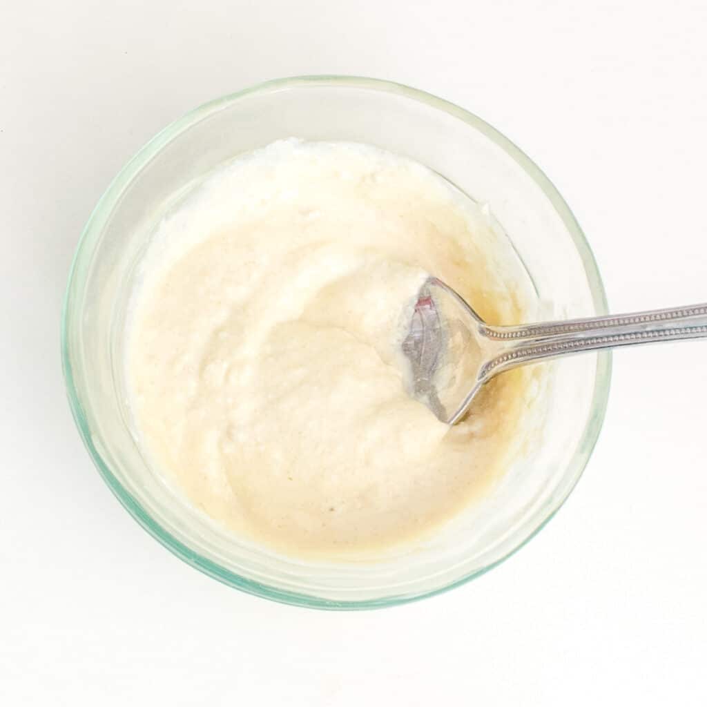 top view of ready vegan cream cheese with stirred sugar in it. 