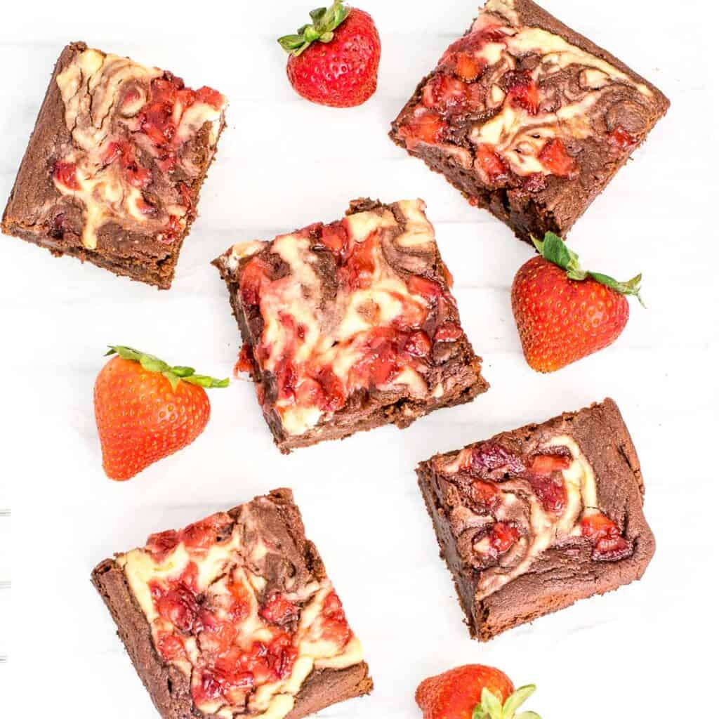 top view of scattered sliced strawberry cheesecake brownies.