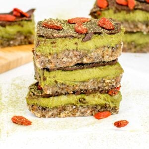 a front view of stacked matcha bars with more of them in the background.