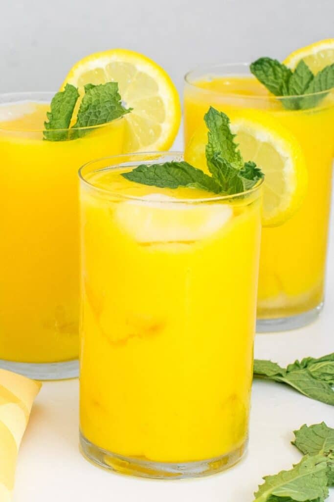 Tall glasses filled with mango lemonade.