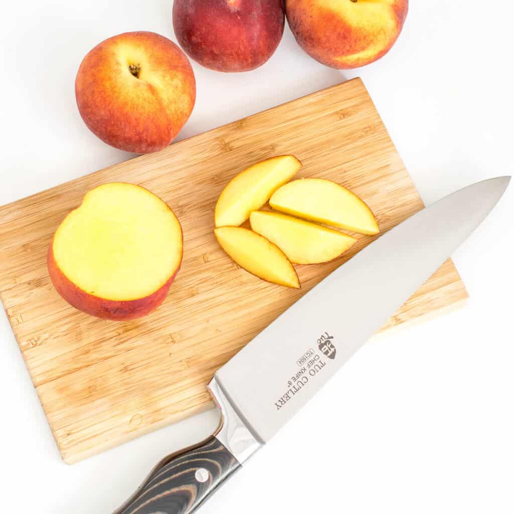 top view of the cut fruit with the knife on a wooden board.