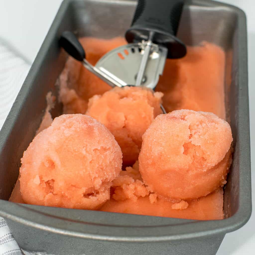 a close up view of scooped watermelon ice cream.