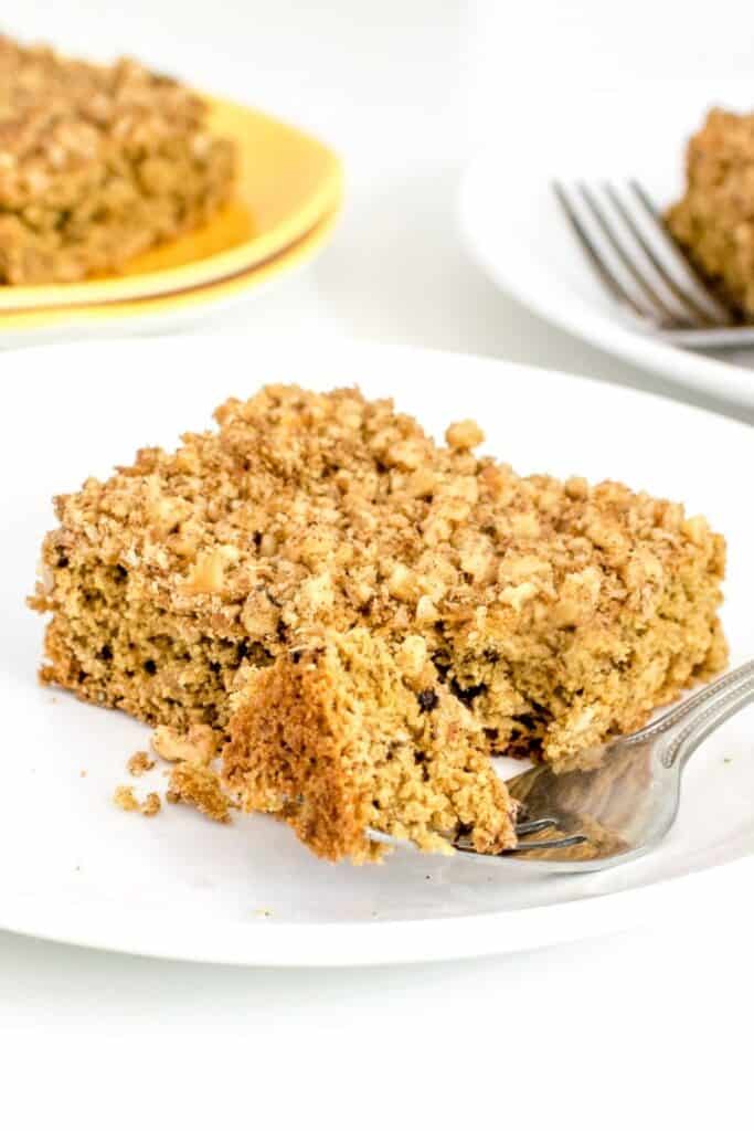 a close up view of vegan coffee cake with a fork. 