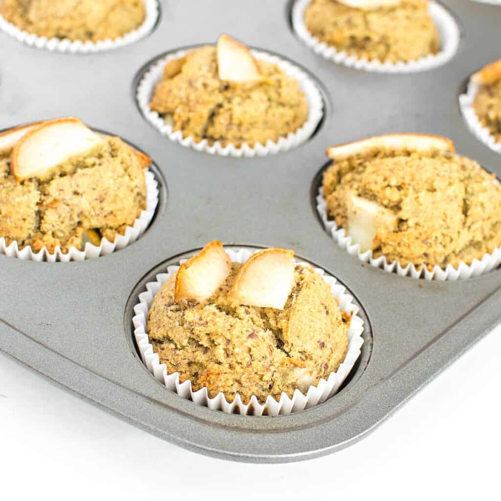 a 45 degree angle view of pear muffins in the tray.