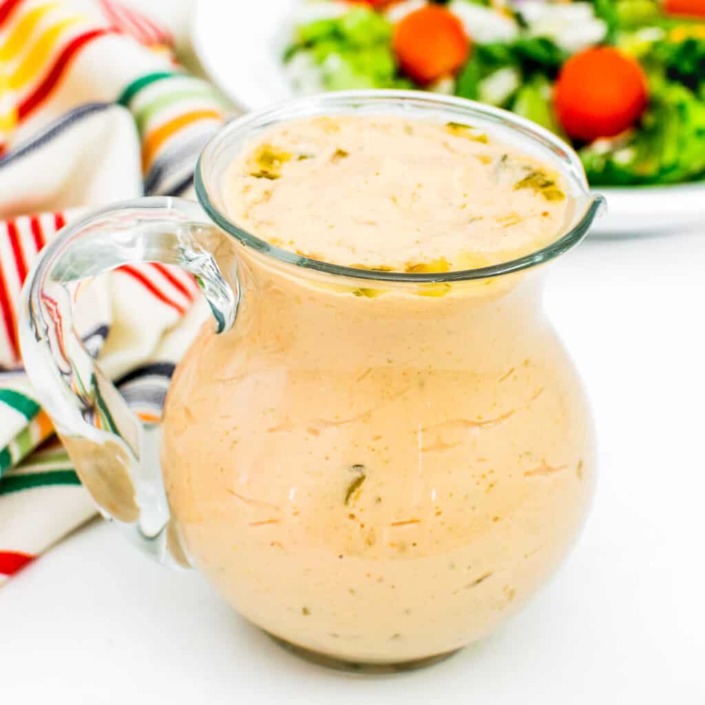 a front view of vegan thousand island dressing in a glass jar.