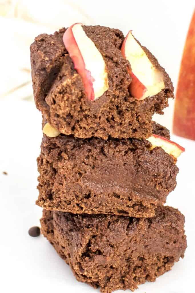 a front view of stacked vegan applesauce brownies.