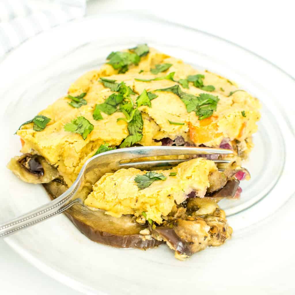 a fork digging into eggplant casserole.