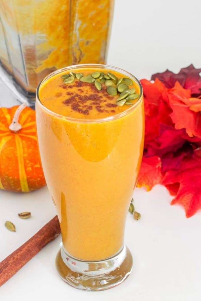 a tall glass filled with vegan pumpkin smoothie.