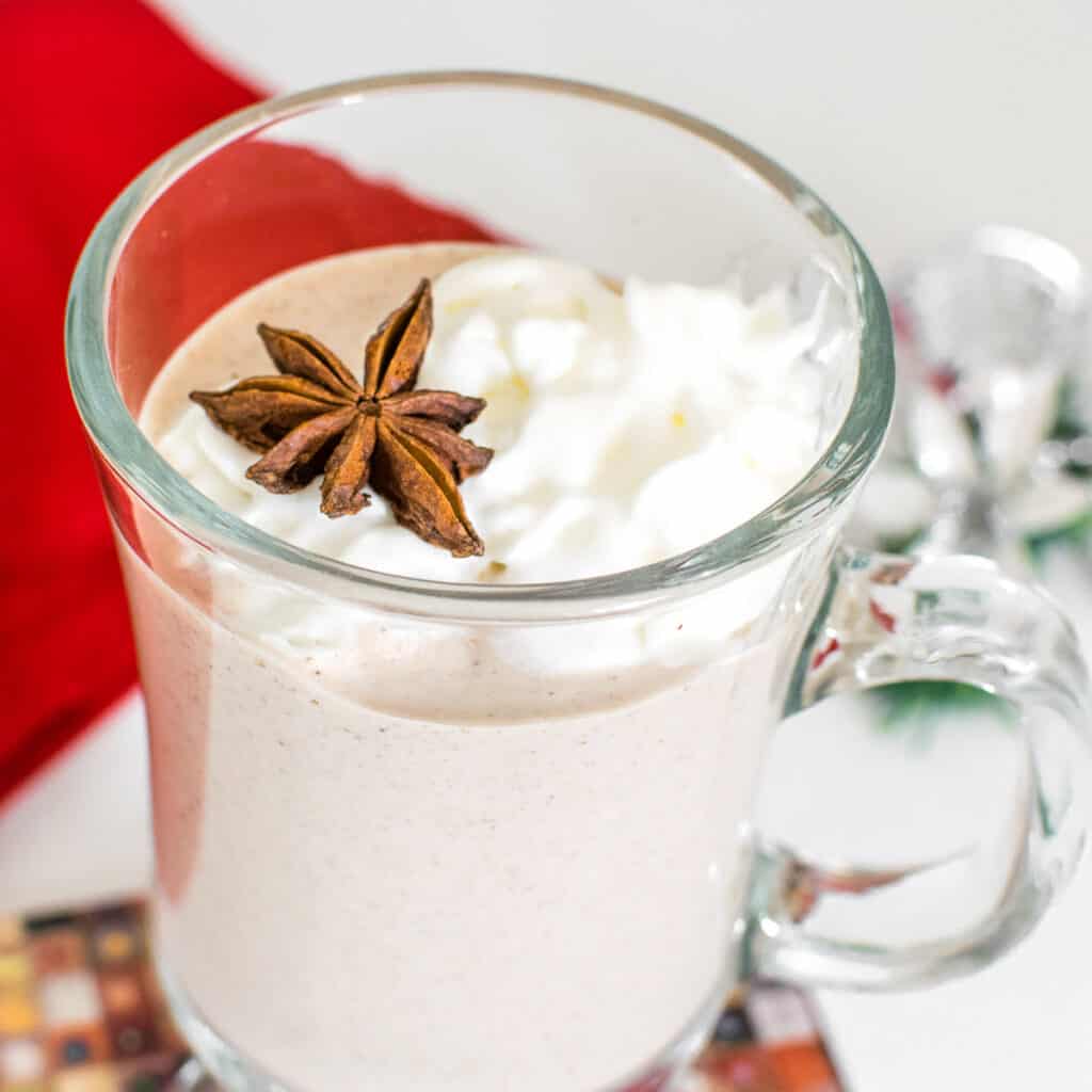 a close up view of a glass with vegan eggnog.