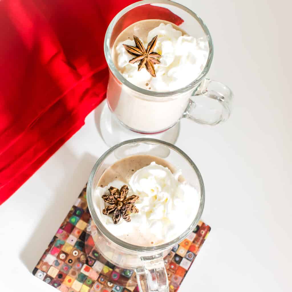 top view of vegan eggnog in the serving glasses with the toppings.