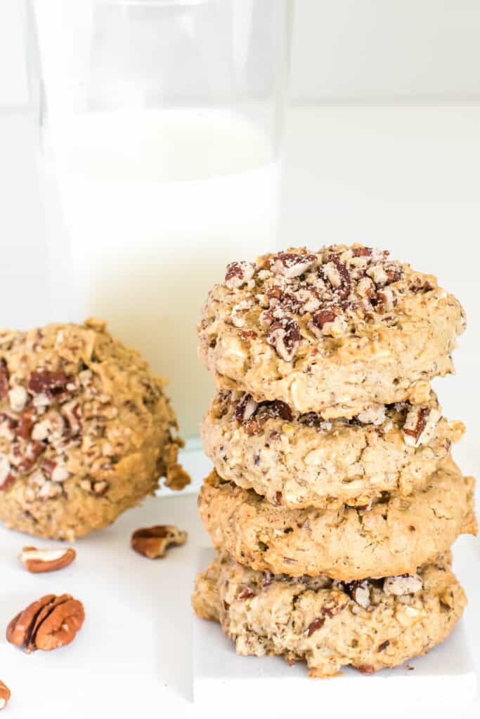 stacked vegan cookies with a glass of milk at the background. 