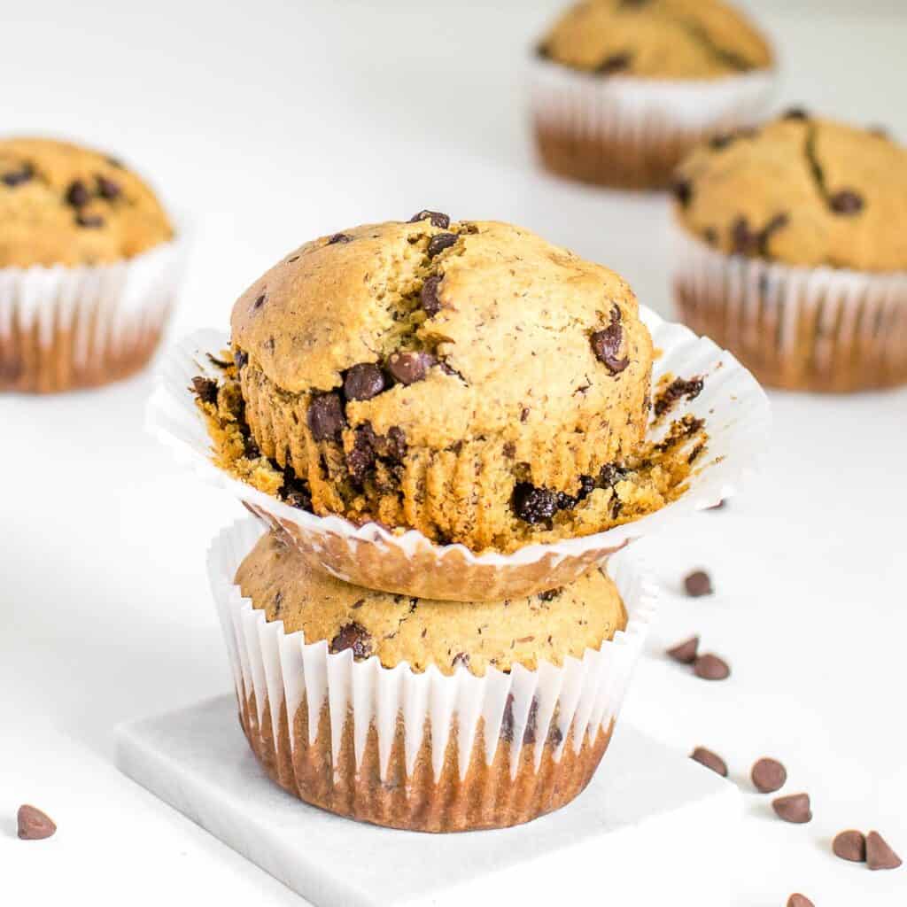 stacked vegan chocolate chip muffins with the open liner.