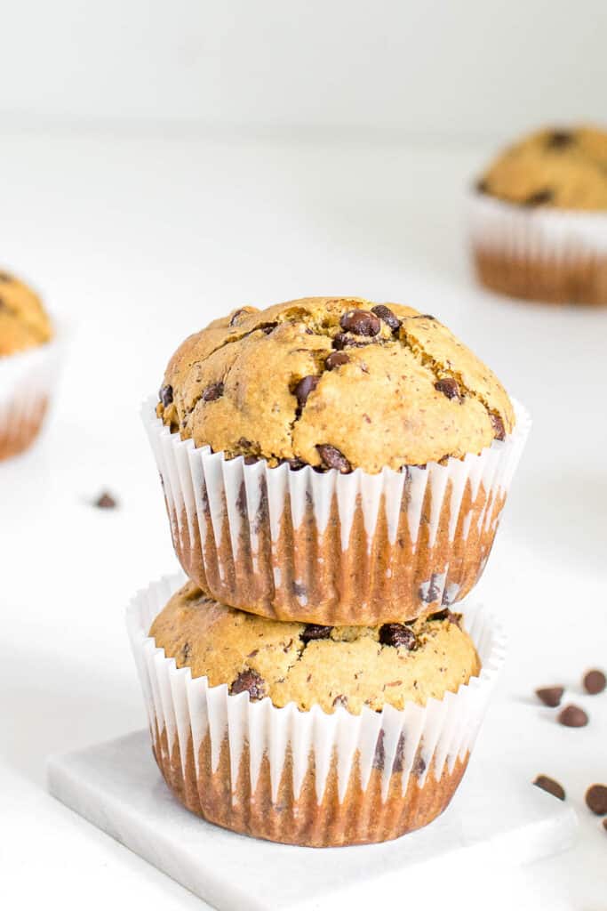 a front close up view of stacked vegan chocolate chip muffins.