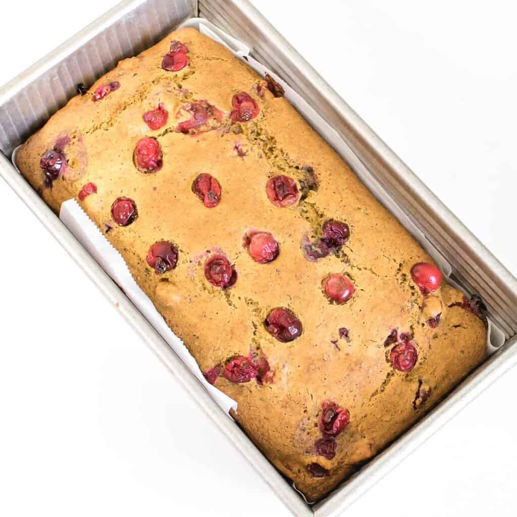 top view of fresh baked cranberry orange bread out of the oven.
