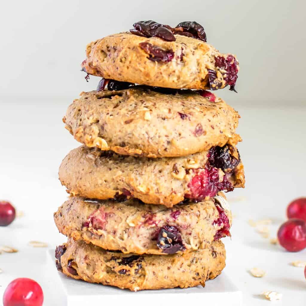 a tall stack of vegan oatmeal cranberry cookies.