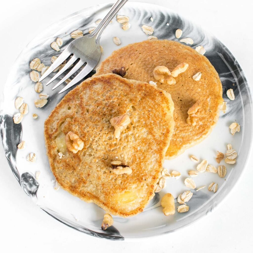 top view of vegan banana oatmeal pancakes in a serving plate.