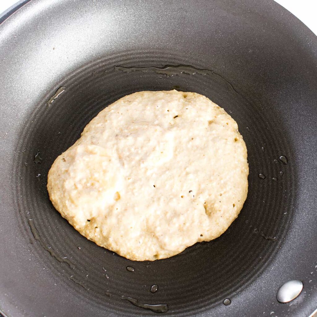 round shaped batter getting cooked in the pan.