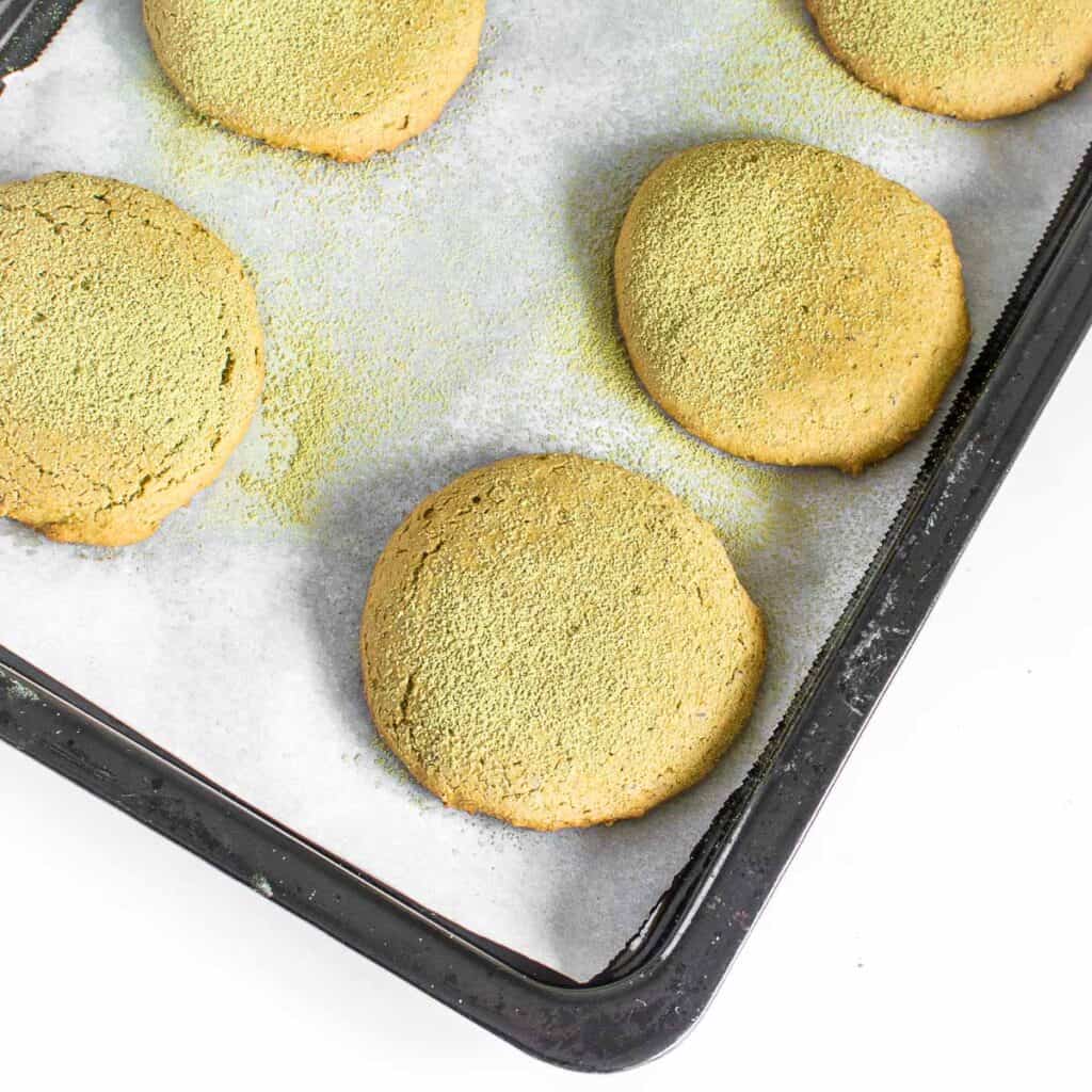 top view of freshly baked matcha cookies in the cooking sheet.