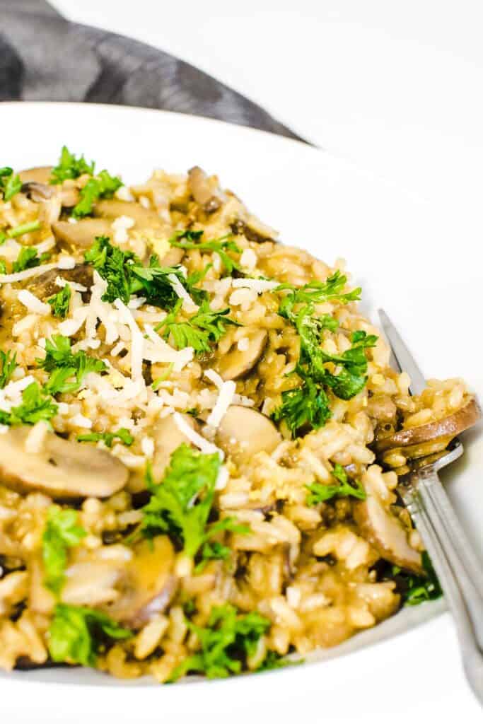 a close up view of brown rice mushroom risotto.