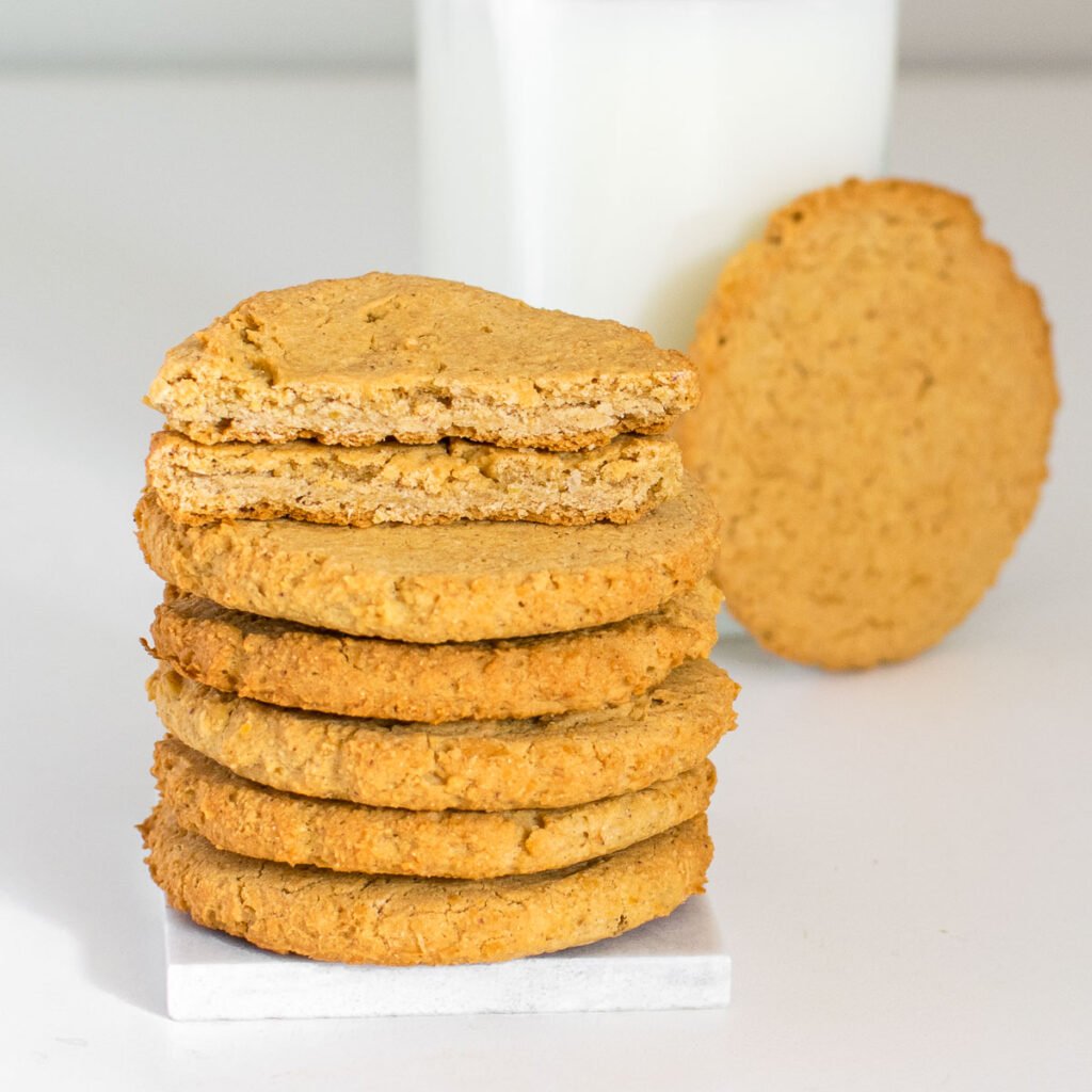a stack of chickpea cookies with a broken one at its top. 