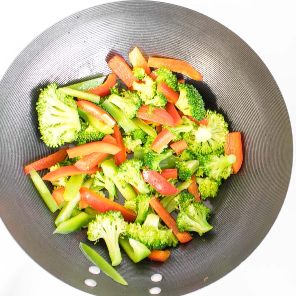 more veggies sautéed in a wok. 