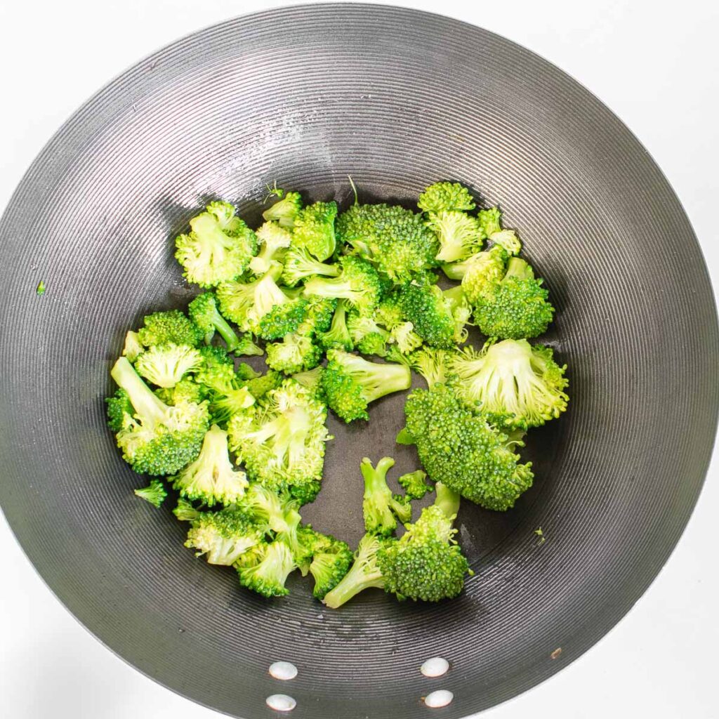 sautéed broccoli in a wok. 