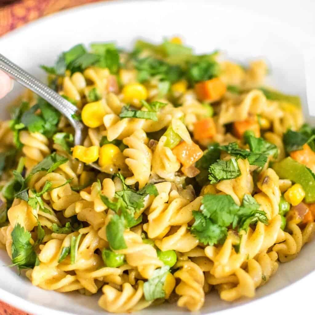 a fork digging into masala pasta