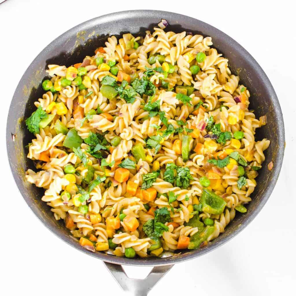 top view of cooked masala pasta in the pan ready to be served.