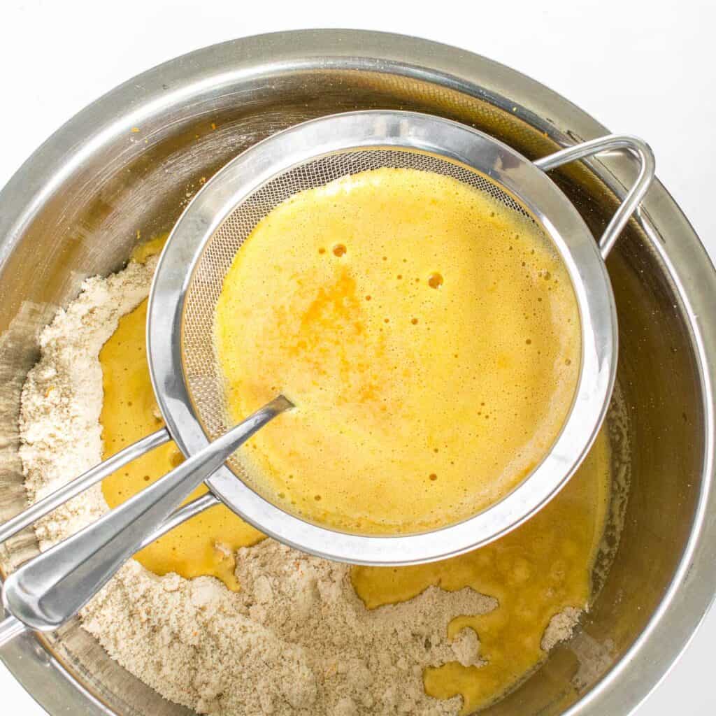 juice being strained into the flour mixture.