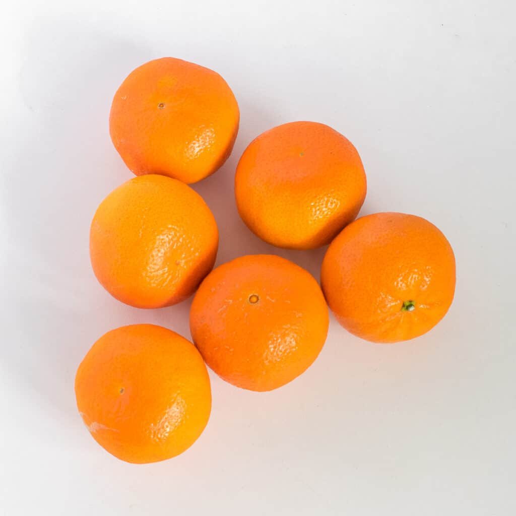 raw oranges on a surface.