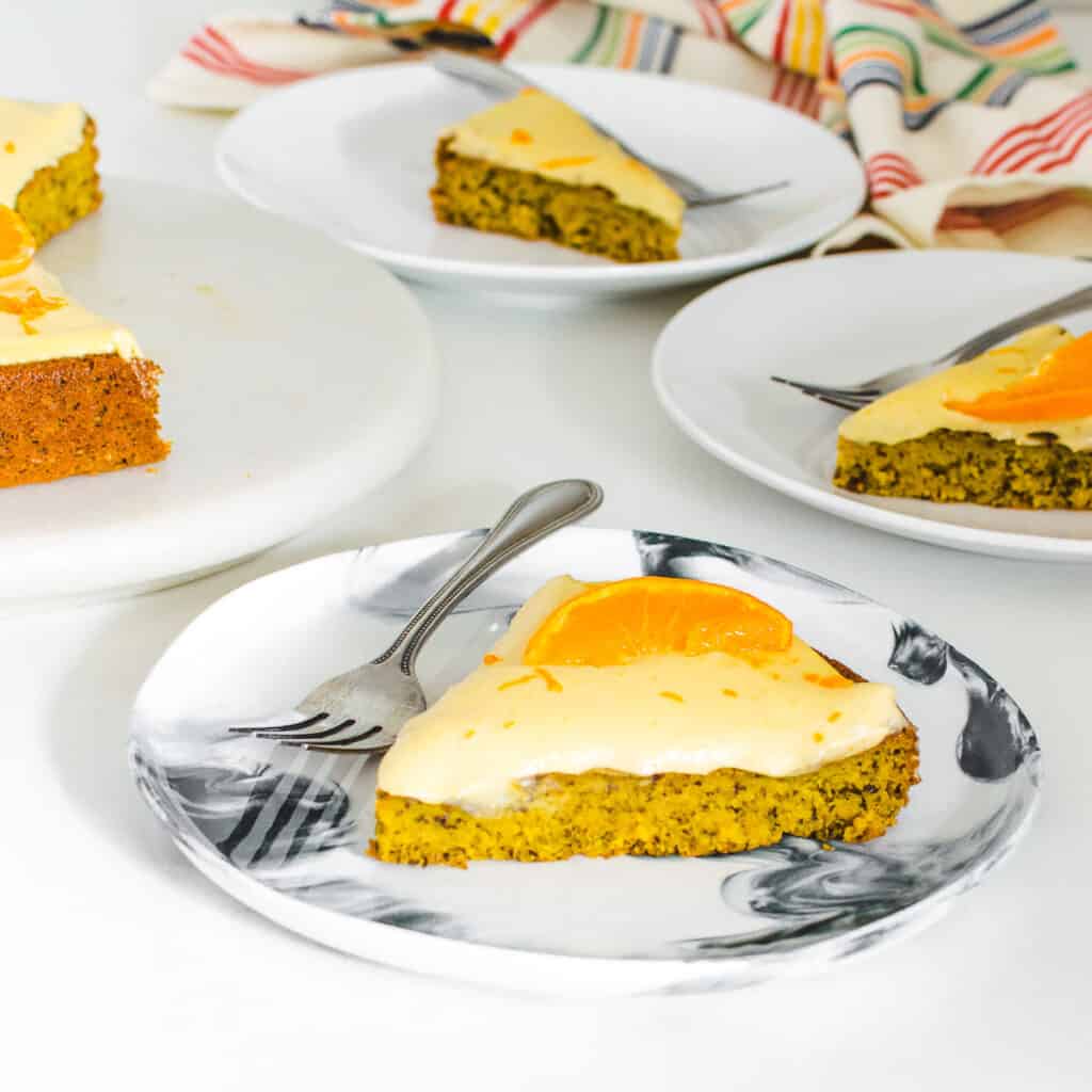 a 45 degree angle view of served slices of vegan orange cake.