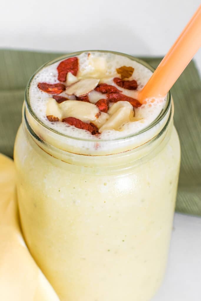 a close up view of pineapple banana smoothie.