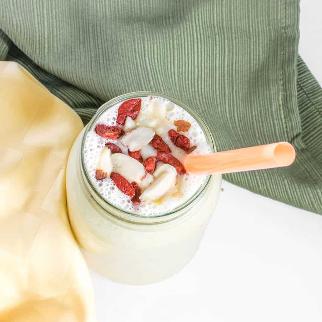 top view of pineapple banana smoothie with garnishes.